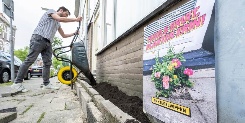 man werkt aan geveltuintje